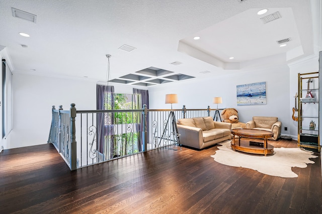 living area with coffered ceiling, crown molding, hardwood / wood-style flooring, and a textured ceiling