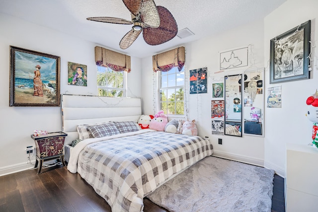 bedroom featuring ceiling fan, a textured ceiling, and dark hardwood / wood-style floors