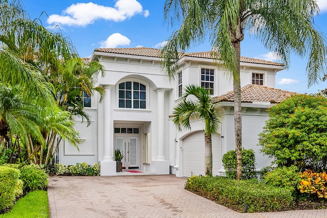 mediterranean / spanish-style home with a garage