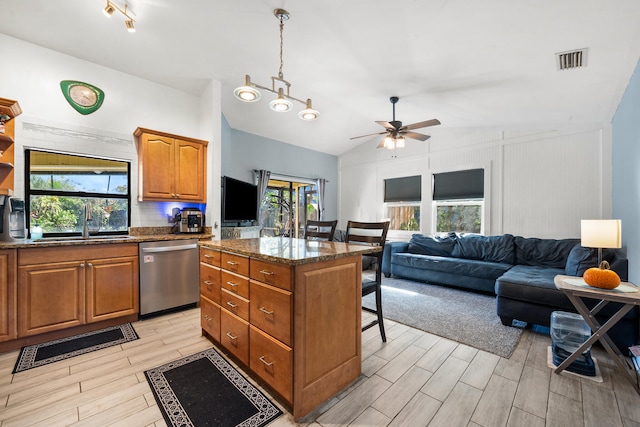 kitchen featuring dishwasher, vaulted ceiling, plenty of natural light, and a kitchen island