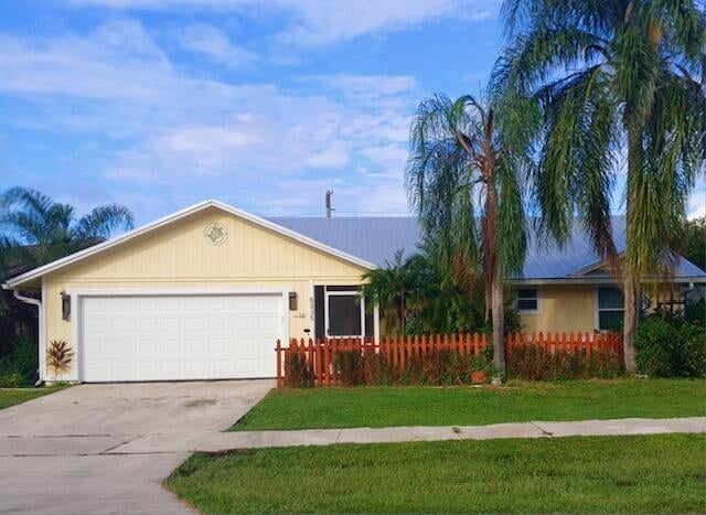 ranch-style house with a front yard and a garage