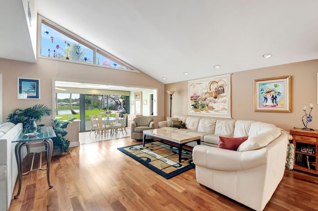 living room with high vaulted ceiling and wood-type flooring