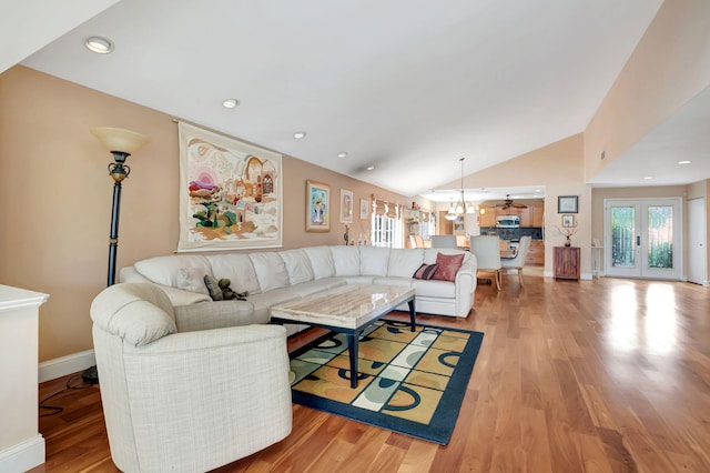 living room with lofted ceiling and light wood-type flooring