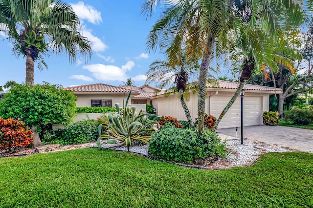 view of front of home with a front yard and a garage