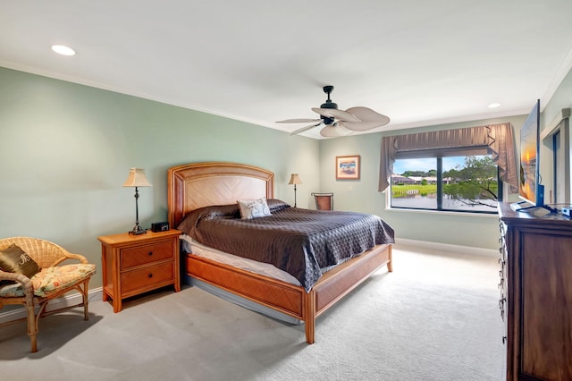 bedroom with ceiling fan, crown molding, and light colored carpet