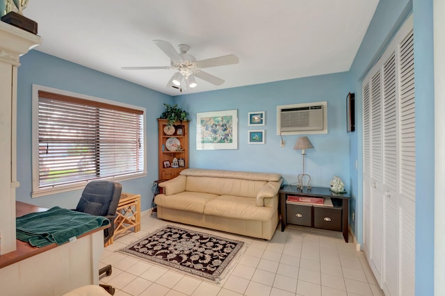 tiled office space featuring a wall mounted AC and ceiling fan