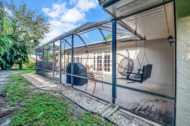 view of patio featuring area for grilling and a lanai