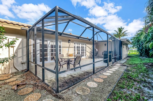 view of patio / terrace with grilling area and glass enclosure