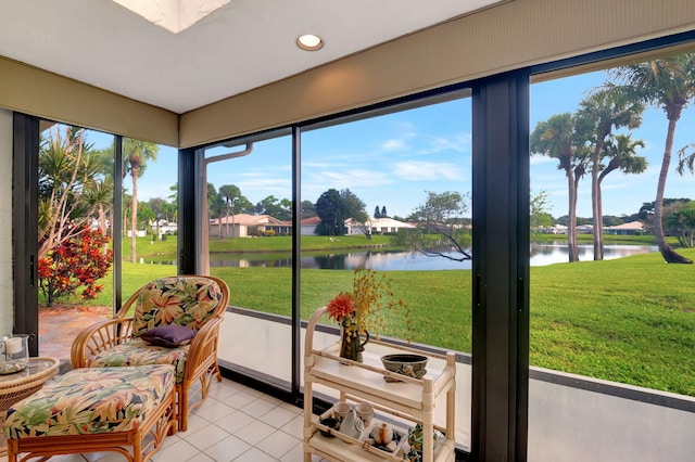 sunroom featuring a water view