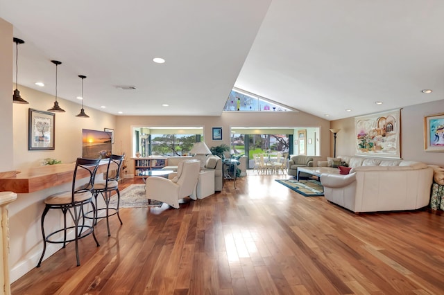 living room with lofted ceiling and hardwood / wood-style floors