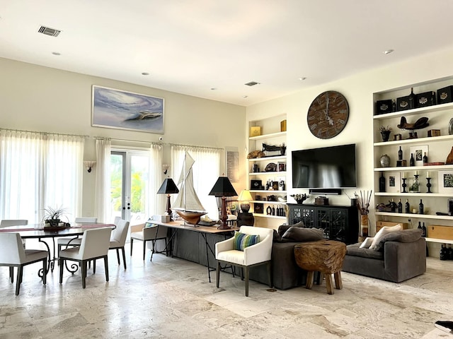 living room featuring built in shelves