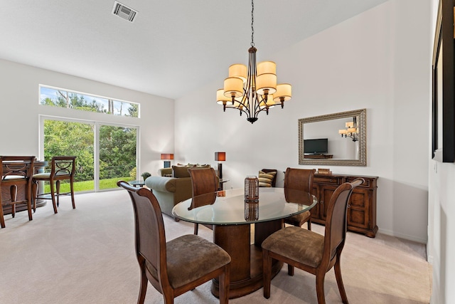 dining space featuring light carpet, an inviting chandelier, and vaulted ceiling