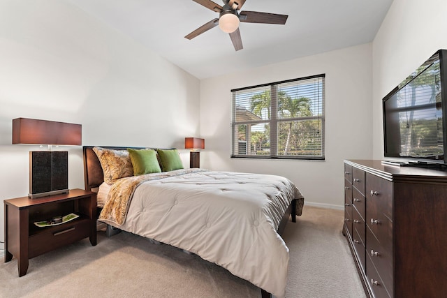 bedroom featuring light carpet, vaulted ceiling, and ceiling fan