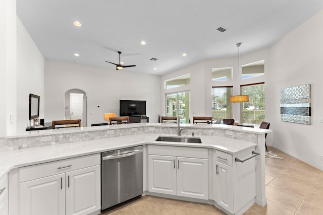 kitchen featuring a sink, light stone countertops, dishwasher, and white cabinetry