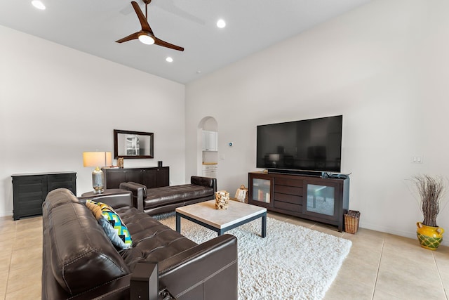 living area featuring recessed lighting, light tile patterned flooring, ceiling fan, baseboards, and arched walkways