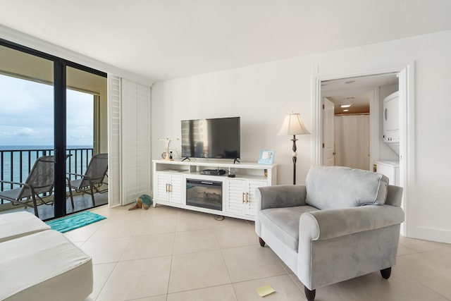 living room featuring a water view and light tile patterned floors