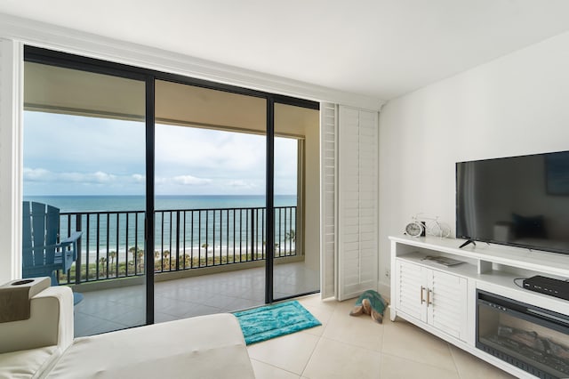 living room featuring a water view and light tile patterned floors