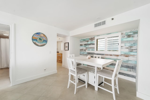 tiled dining space with wooden walls