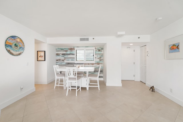 unfurnished dining area with light tile patterned flooring