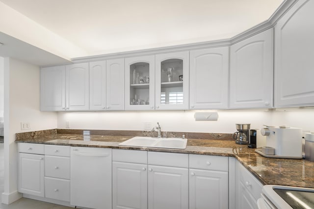 kitchen featuring sink, white cabinetry, white dishwasher, and range