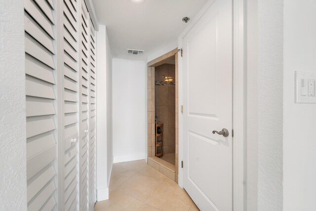 corridor featuring light tile patterned floors