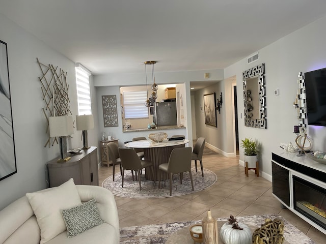 dining room with a chandelier and light tile patterned flooring