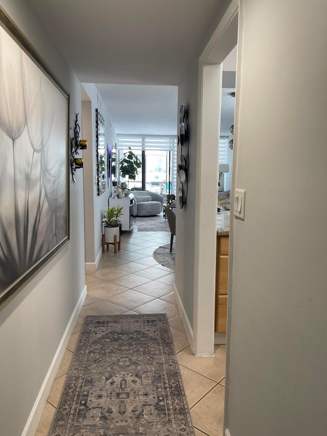 hall featuring light tile patterned flooring