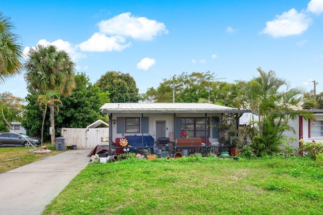 view of front of home with covered porch and a front lawn