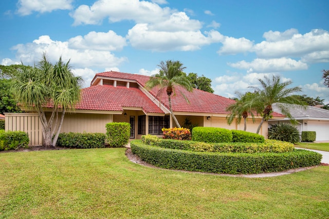 mediterranean / spanish house featuring a front yard