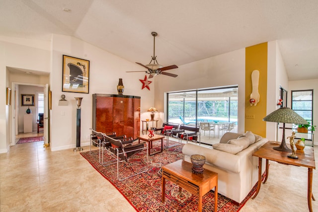 living room with ceiling fan, a textured ceiling, and vaulted ceiling