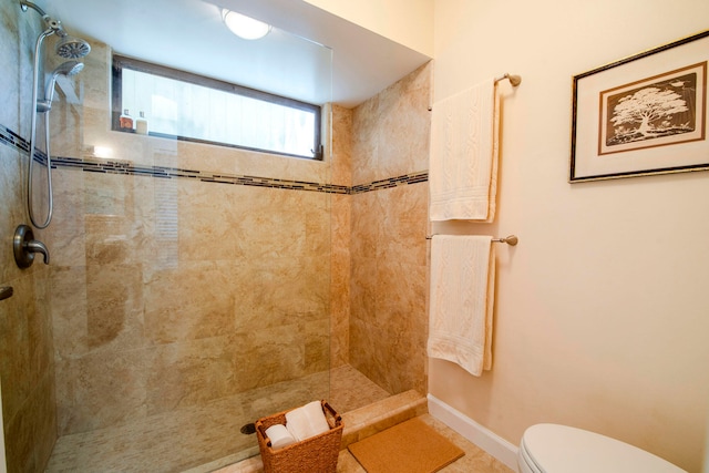 bathroom with toilet and tiled shower