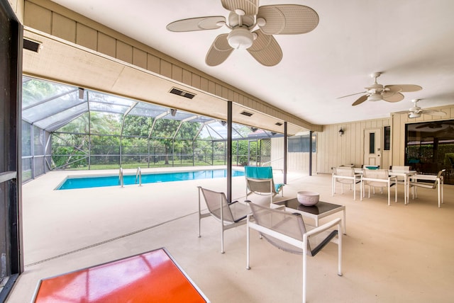 view of pool with a lanai, a patio, and ceiling fan