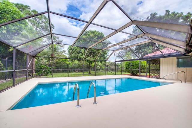 view of pool featuring a patio area and glass enclosure