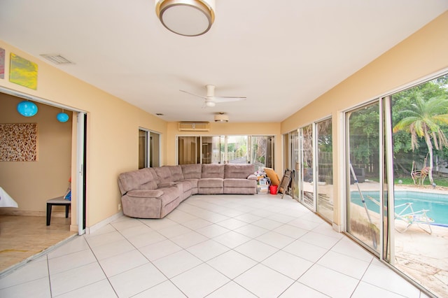 unfurnished sunroom with ceiling fan