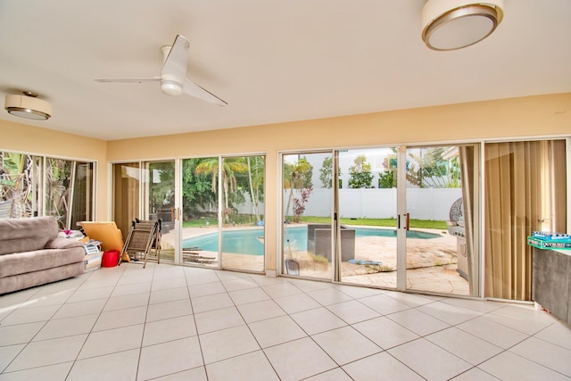 unfurnished sunroom with ceiling fan