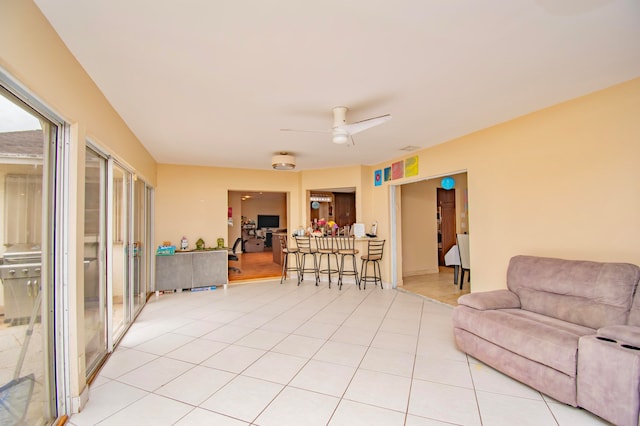 tiled living room featuring ceiling fan