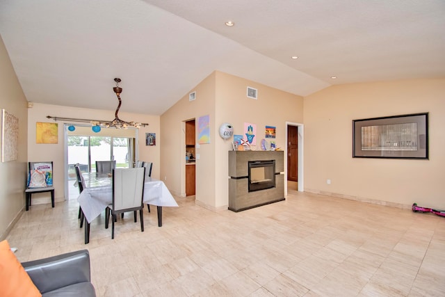 dining space featuring a notable chandelier and lofted ceiling