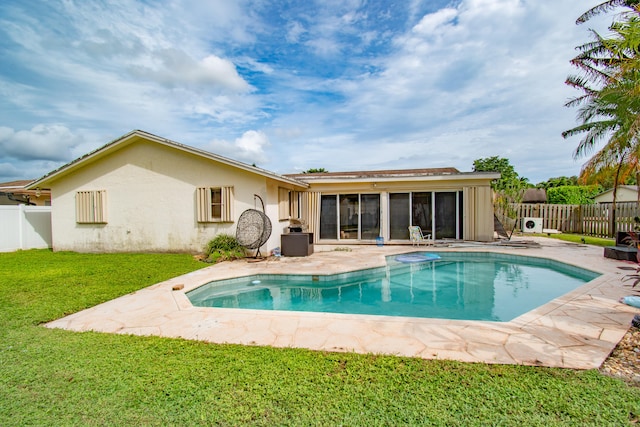 back of property featuring a patio, a fenced in pool, a yard, and a sunroom