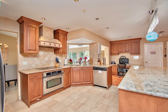 kitchen featuring kitchen peninsula, decorative backsplash, premium range hood, light stone countertops, and stainless steel appliances