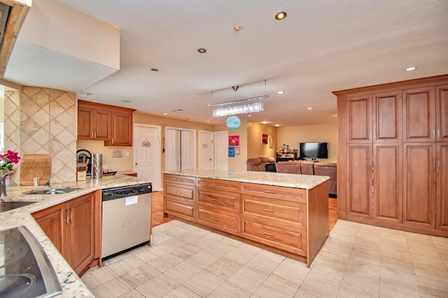 kitchen with decorative light fixtures, tasteful backsplash, stainless steel dishwasher, and light stone counters