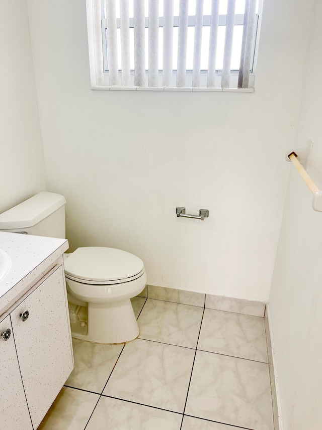 bathroom featuring tile patterned floors, toilet, and vanity