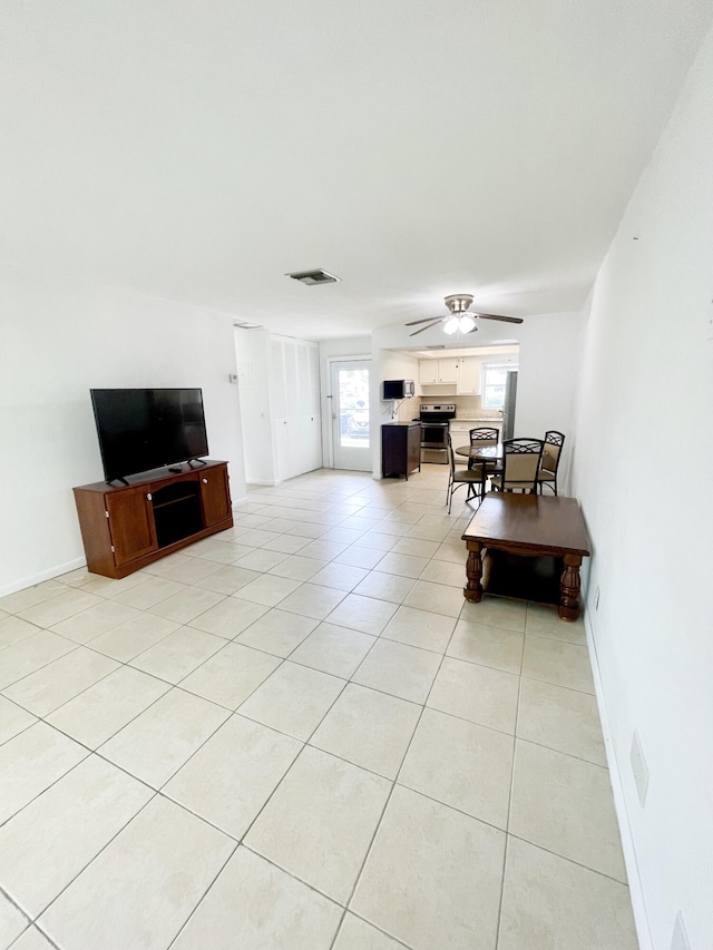 living room with light tile patterned floors and ceiling fan