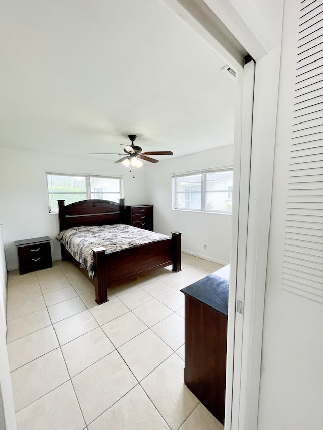 bedroom featuring light tile patterned floors and ceiling fan