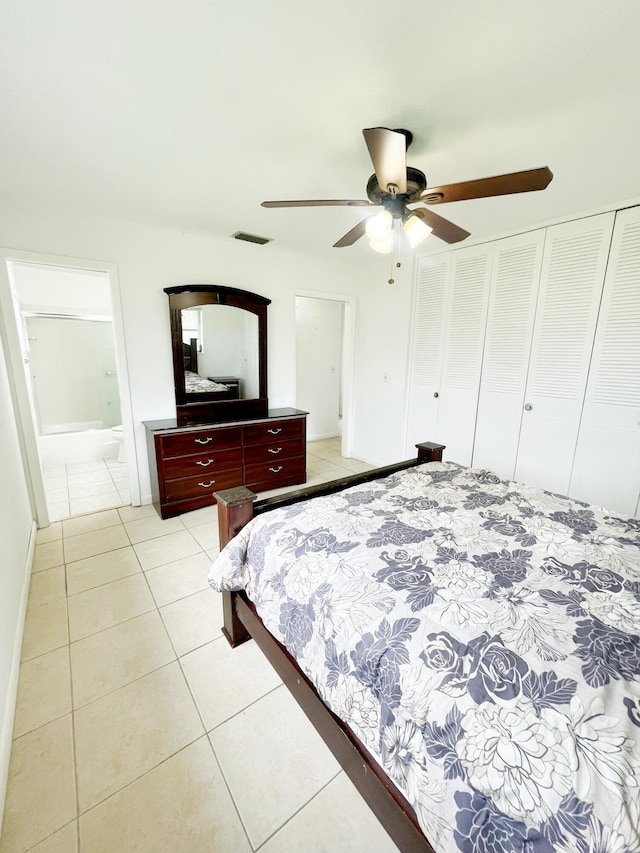 tiled bedroom featuring ceiling fan and a closet