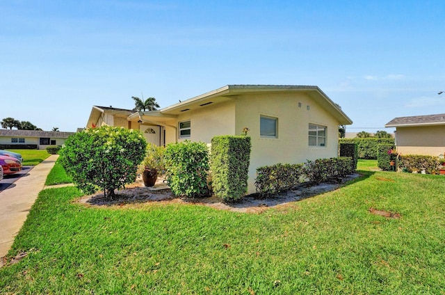 view of side of home featuring a yard