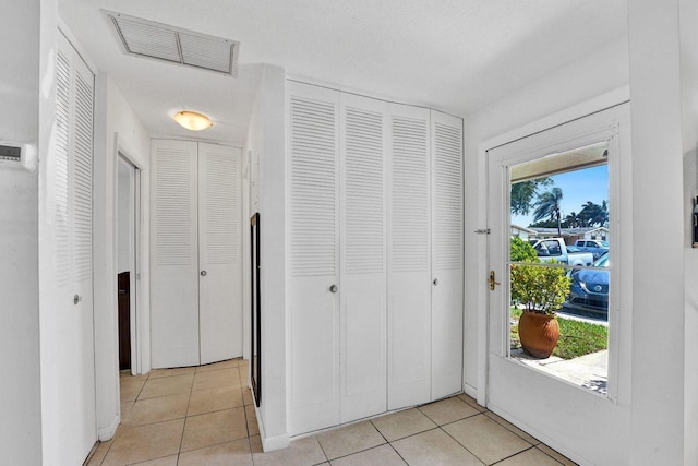 entryway featuring light tile patterned floors