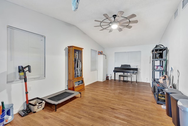 interior space with light hardwood / wood-style floors, ceiling fan, and lofted ceiling