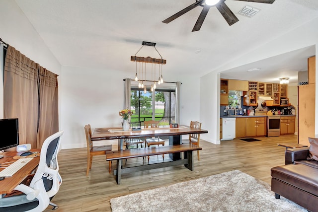 dining area with ceiling fan, sink, light hardwood / wood-style floors, and lofted ceiling