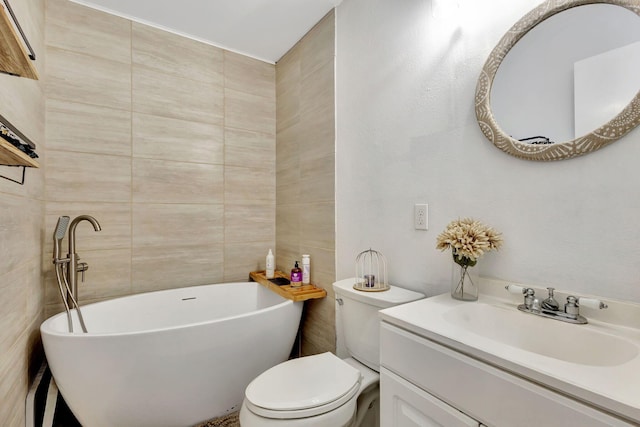 bathroom featuring vanity, a bathtub, toilet, and tile walls