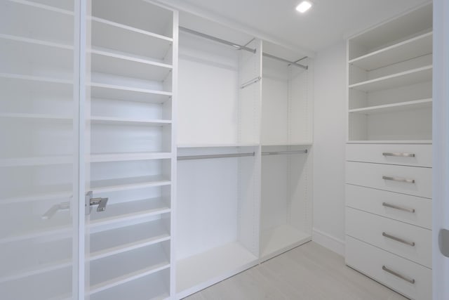 walk in closet with hardwood / wood-style floors